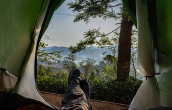 camping solo at tea garden hill top with mesmerizing view image taken at ooty tamilnadu india. Showing beautiful nature love of human.